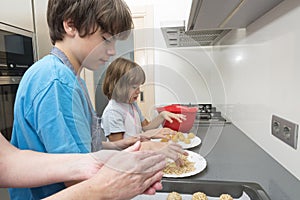 Family preparing sweets in the kitchen photo