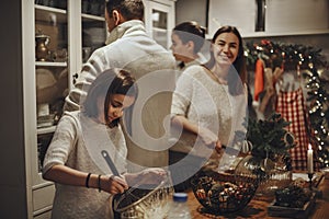 Family preparing traditional festive Christmas Eve dinner together