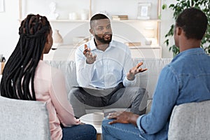 Family Psychotherapy. African American Couple Listening To Counselor`s Advices During Therapy Session