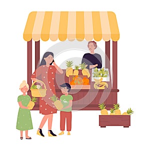 Family purchasing fresh fruit at local market