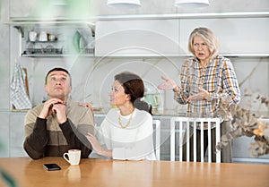 Family quarrel, adult woman calming man