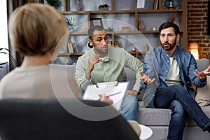 Family quarrel at the reception at the psychologist. LGBT couple at a psychotherapist& x27;s appointment. Psychologist