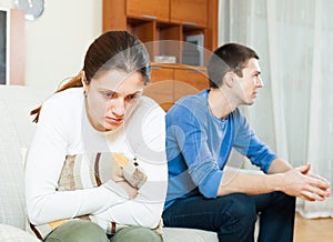 Family quarrel. Sadness woman against unhappy man