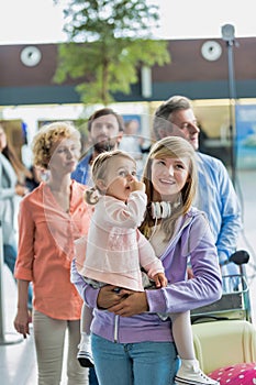 Family queuing for check in at airport