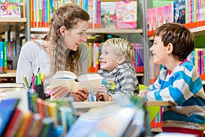 Family reading books in the library