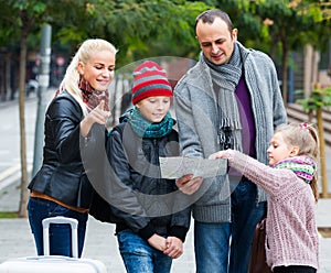 Family reading city map