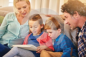 Family, reading and together on couch for teaching with happiness, relationship love and rapport. Parents, young