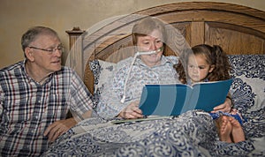 Family reads with woman on oxygen