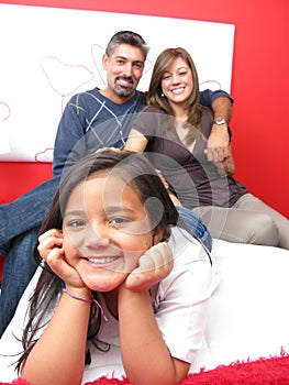 Family reclining in bed