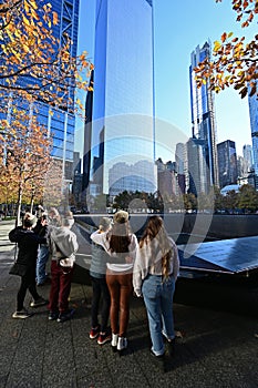 Family at reflecting pool at National September 11 Memorial in New York.