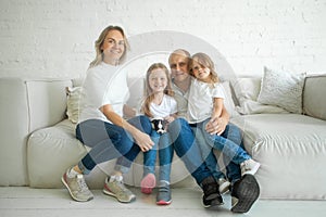 Family and relationship concept. Beautiful and happy smiling young family in white T-shirts are hugging and have a fun time