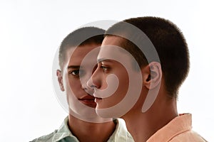 Family relationships concept. Front and side view of two young caucasian twin brothers