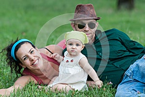 Family relaxes in a meadow photo