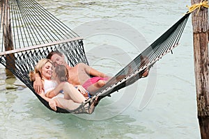 Family Relaxing In Beach Hammock