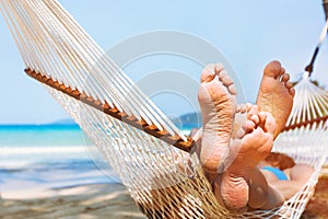 Family relaxing on the beach in hammock, exotic holidays travel