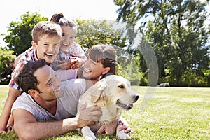 Family Relaxing In Garden With Pet Dog photo