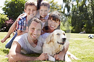 Family Relaxing In Garden With Pet Dog photo