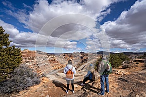 Family relaxing on hiking trail in Utah.