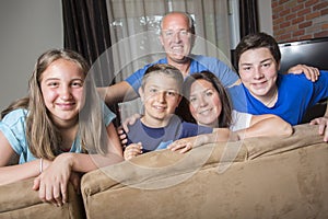 Family Relaxing Indoors Watching Television Together