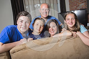 Family Relaxing Indoors Watching Television Together