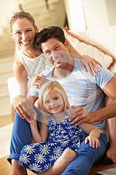 Family Relaxing On Sofa At Home