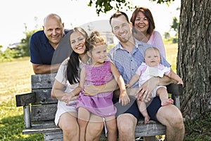 Family relaxing together in nature with grandparent