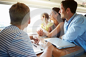 Family Relaxing On Train Journey