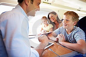 Family Relaxing On Train Journey