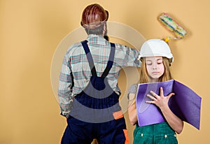 Family remodeling house. Little fathers helper. Father bearded man and daughter hard hat helmet uniform renovating home