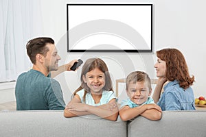 Family with remote control sitting