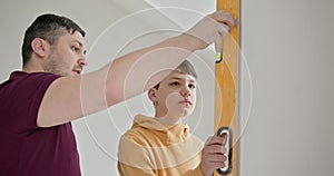 Family Renovating Home Together, Father and Son Painting Walls