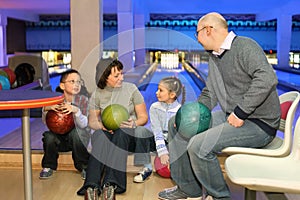 Family in rest and communicate in bowling club
