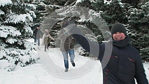 Family rests in winter forest, beautiful landscape with snowy fir trees