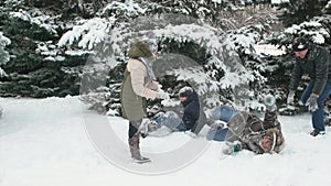 Family rests in winter forest, beautiful landscape with snowy fir trees