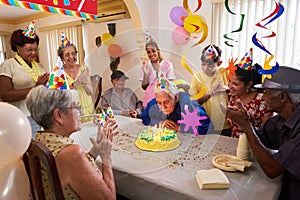 Family Reunion For Birthday Party Celebration In Retirement Home