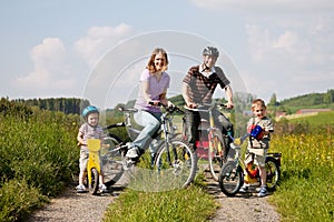 Family riding bicycles in summer