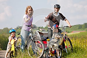 Family riding bicycles in summer