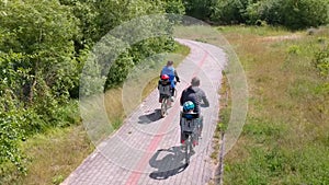 The family is riding bikes on the cycle path