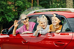 Family road trip. mother with children traveling by car. leaning out of the window