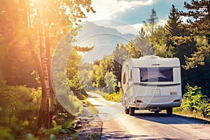 Family road trip travel. Camper van traveling, motorhome on the road through a forest. With copy space