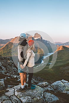 Family romantic couple in Norway hiking mountains. Man and woman in love enjoying sunset nature view