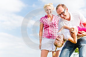 Family romping on field photo