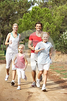 Family running on path in park