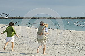 Family running to beach