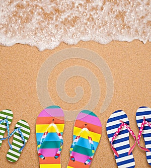 Family's flip flop pairs on sea surf with copy space