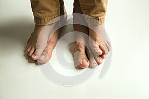 Family`s legs on white studio background, dad and son