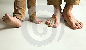 Family`s legs on white studio background, dad and son