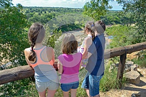 Family safari in Africa, parents and children watching river wildlife and nature, tourists travel in South Africa, Kruger park