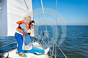 Family sailing. Mother and child on sea sail yacht. photo