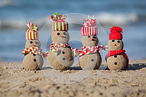 Family of sandy Snowmen at tropical beach.